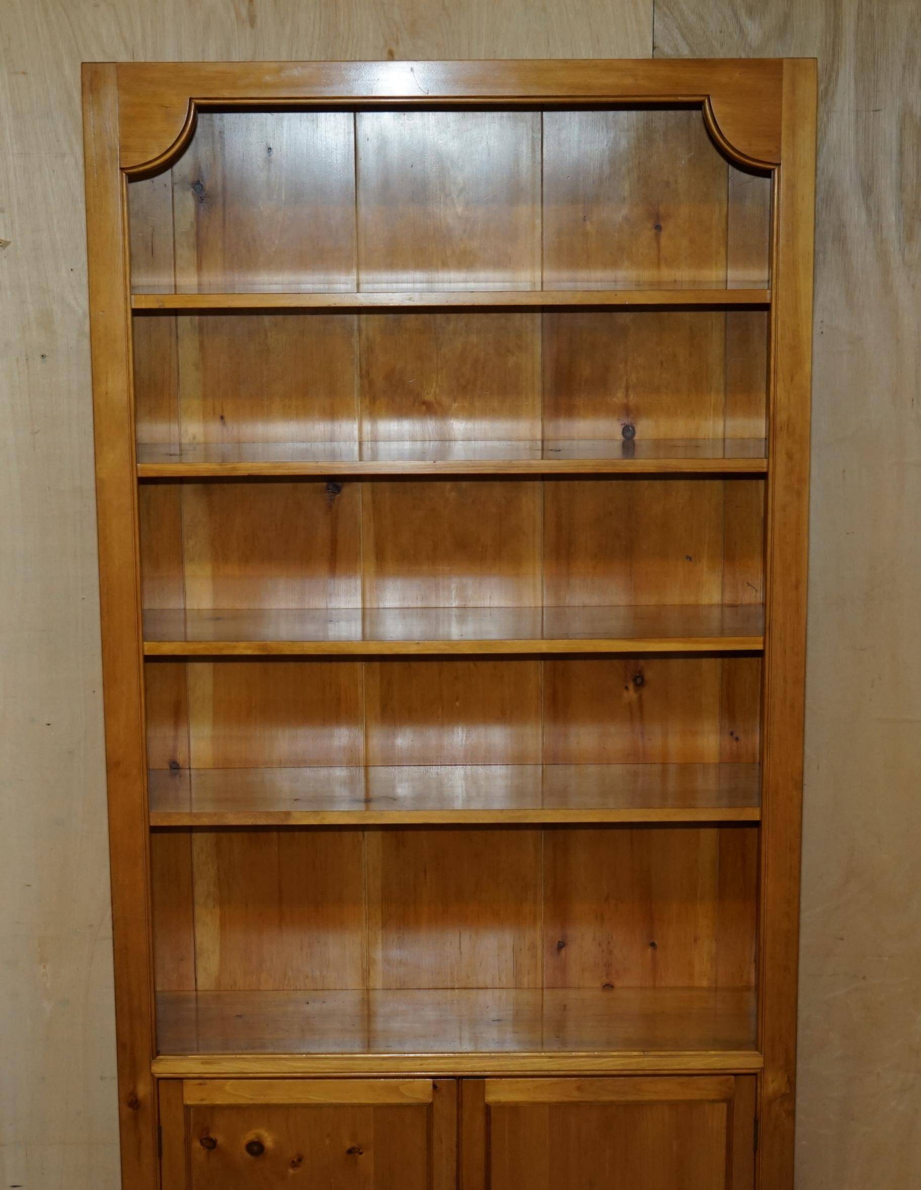 Pair of vintage cherry wood bookcases with lockable doors.