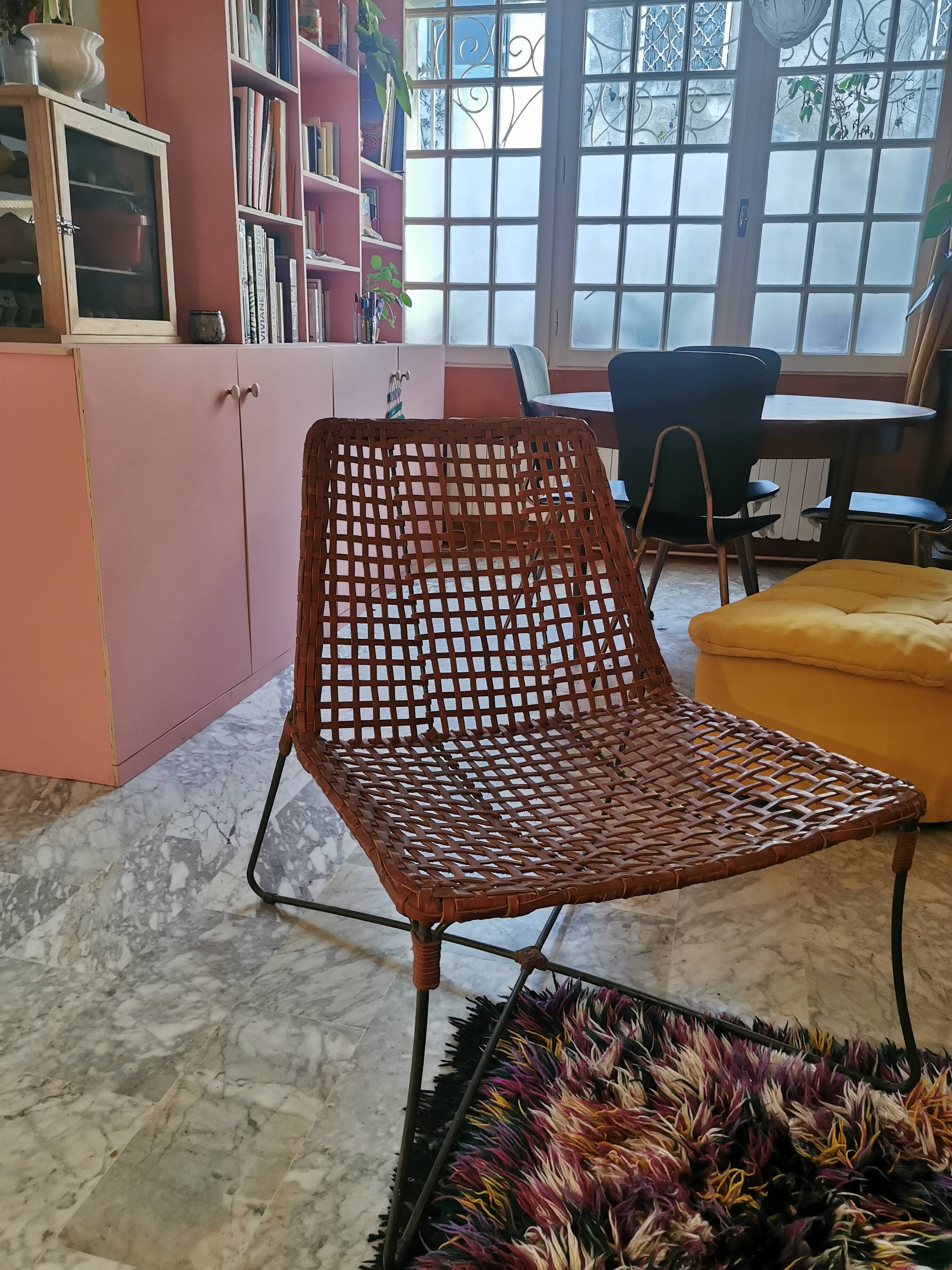 Modernist armchair in woven leather and black metal – 1960s–1970s