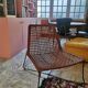 Modernist armchair in woven leather and black metal – 1960s–1970s