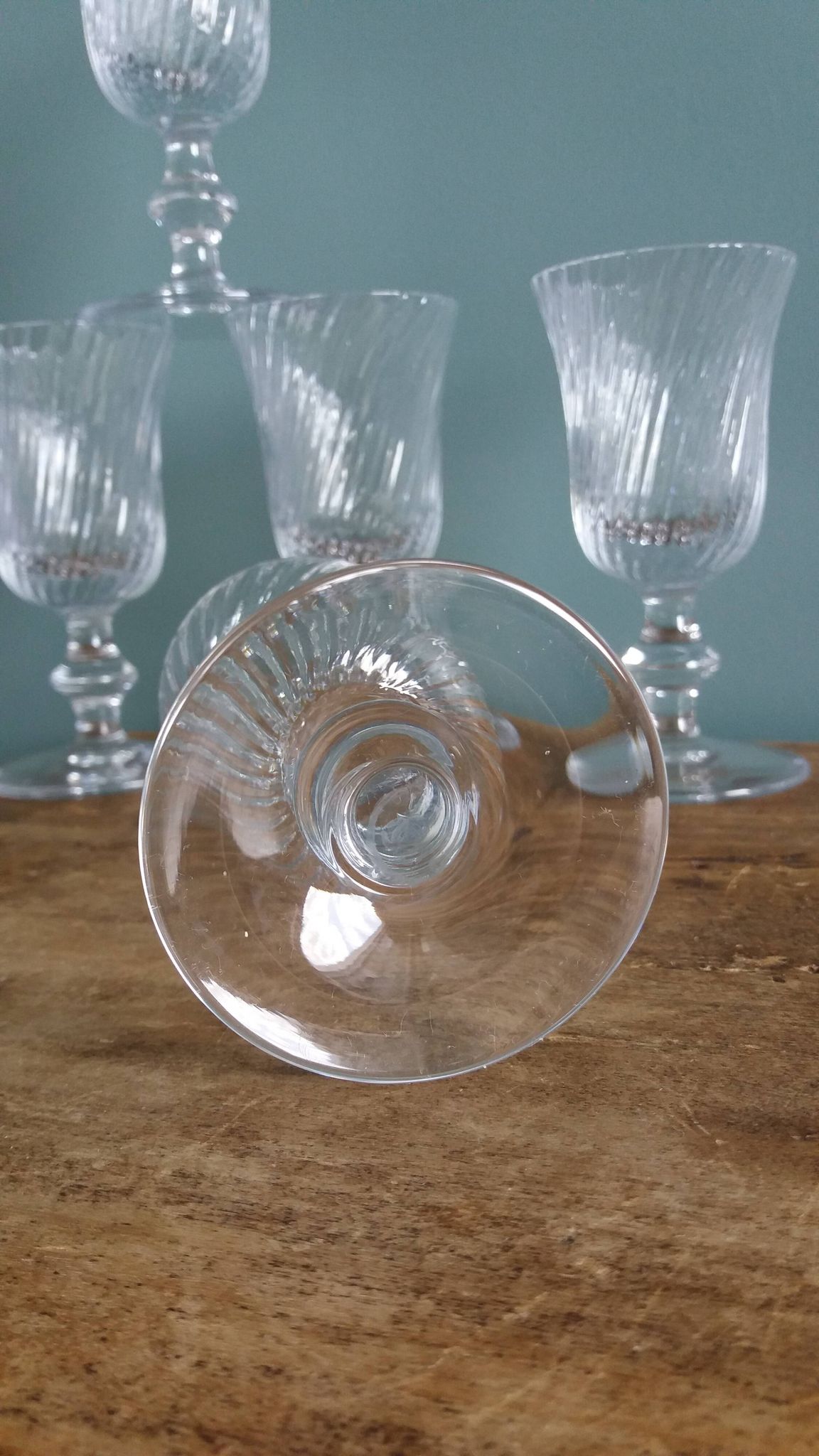 Ancient footed crystal glasses with relief twisted fluted goblets.