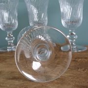 Ancient footed crystal glasses with relief twisted fluted goblets.