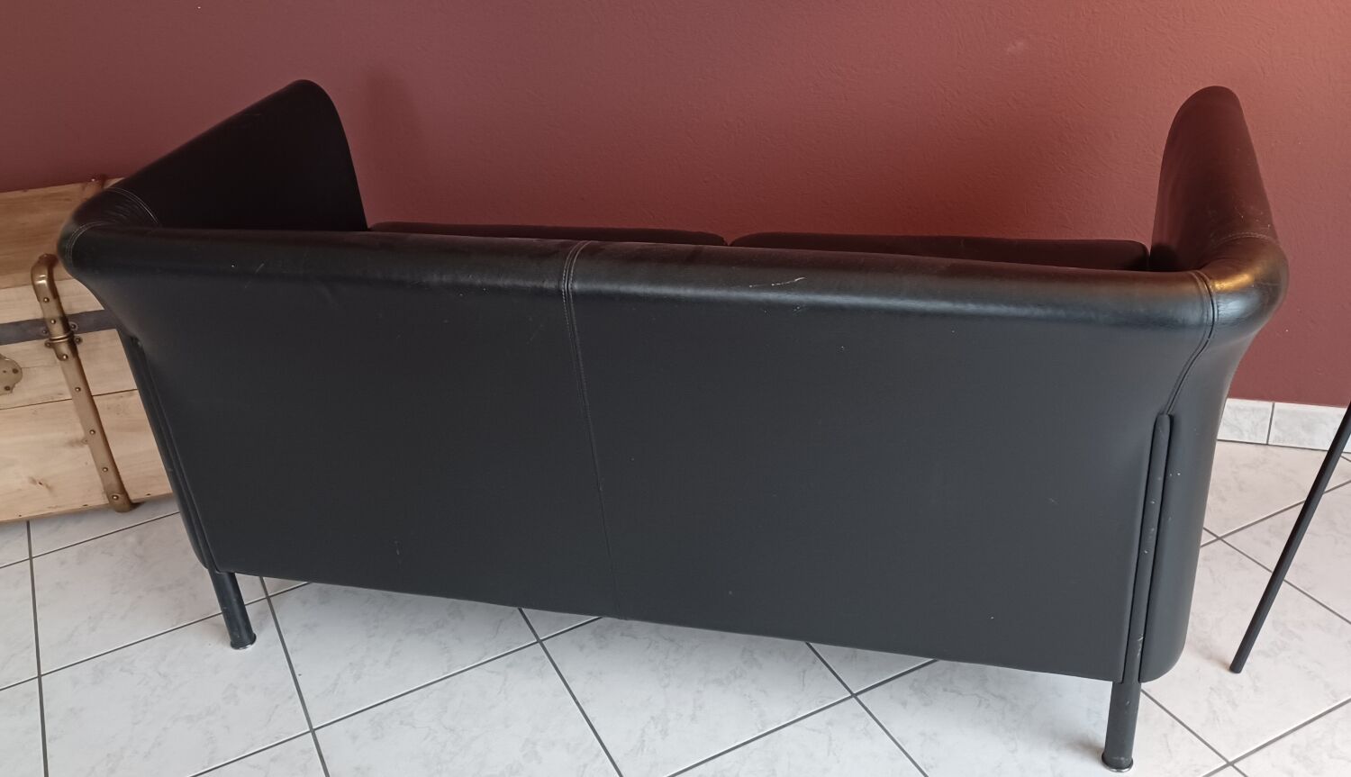 Black leather two-seater sofa