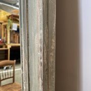 Antique mirror with a green and white patina.