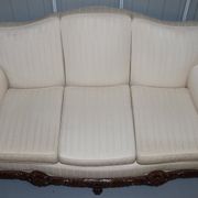 Three-seater canapé carved from solid walnut with claw feet.