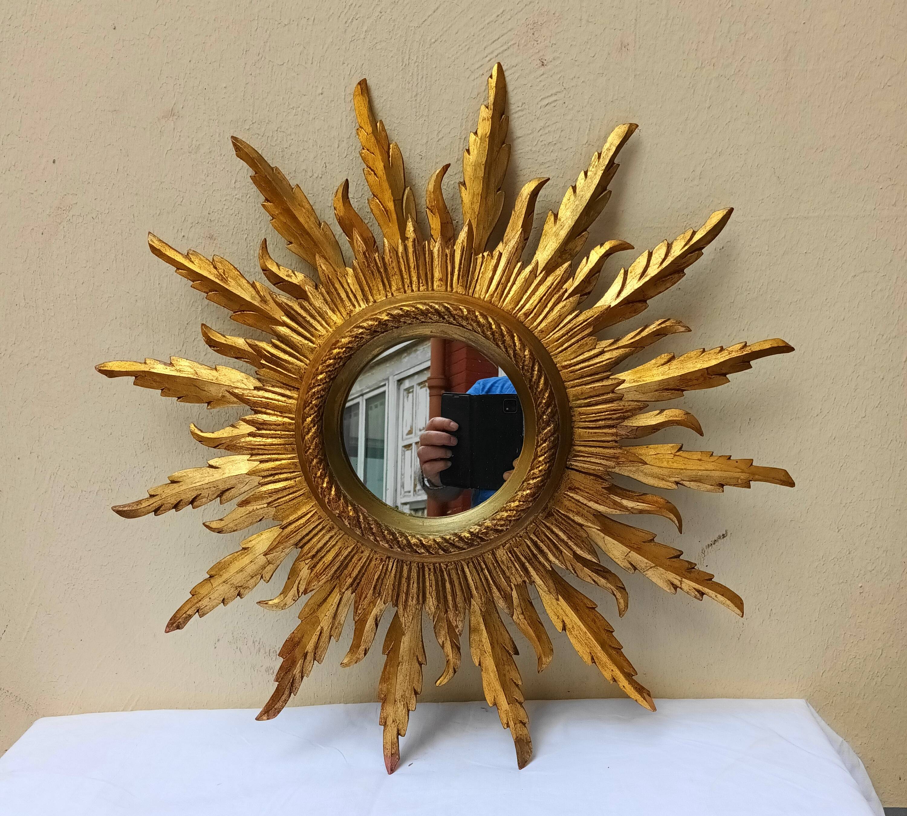 Sun mirror in carved gilded wood from the 1950s
