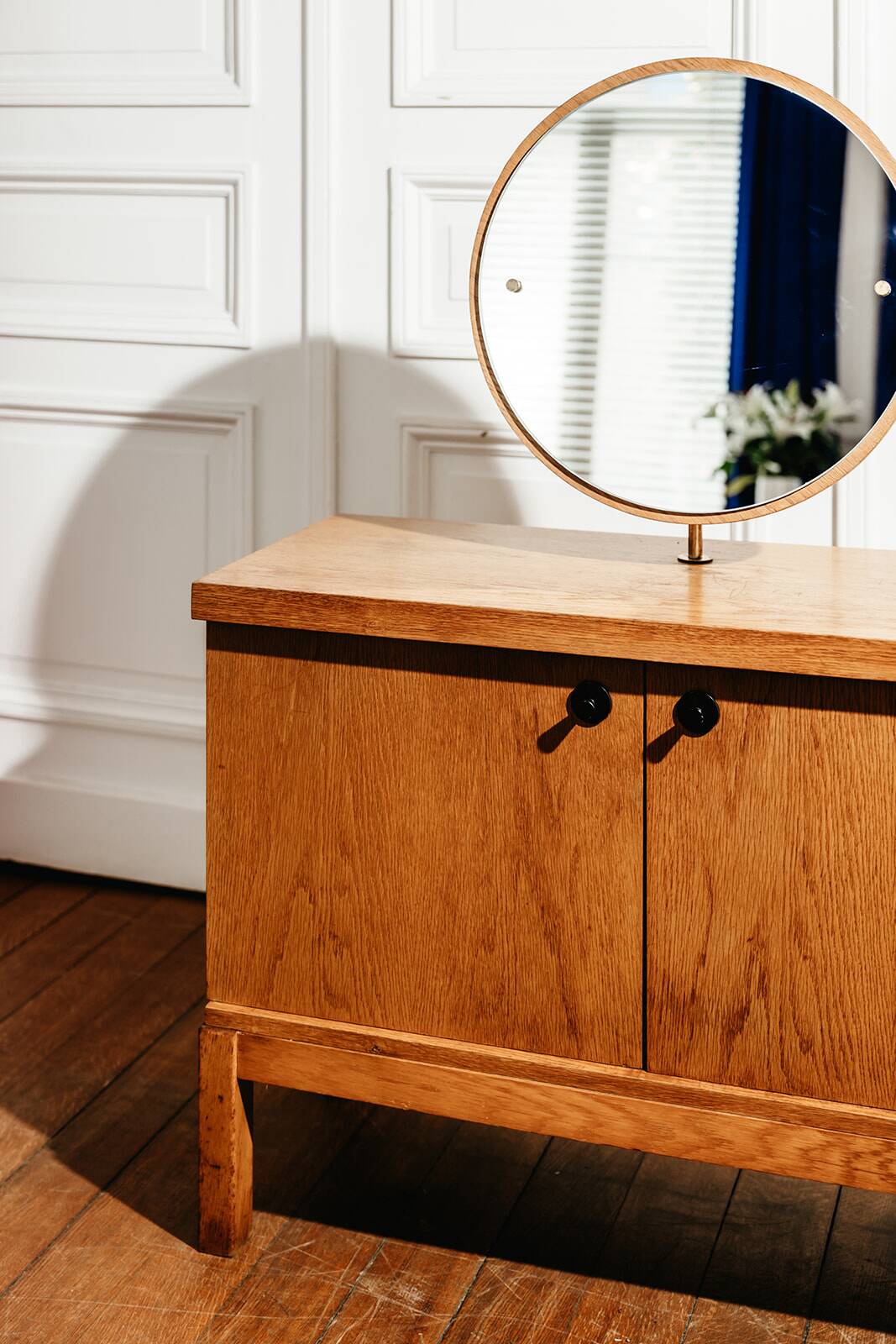 Vintage oak cabinet with circular mirror, 1960s modernist design.