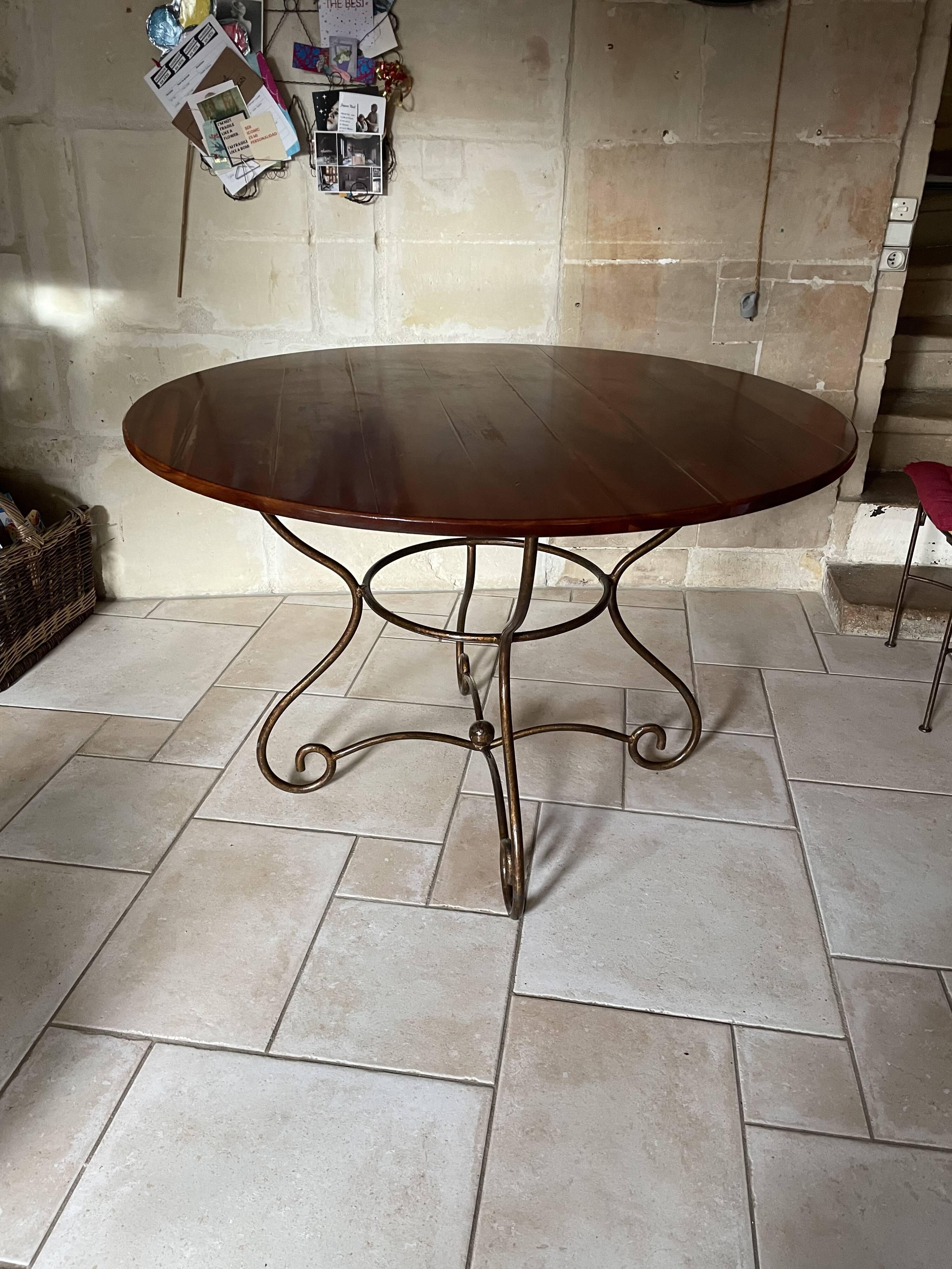 Table and four wrought iron and wood chairs.