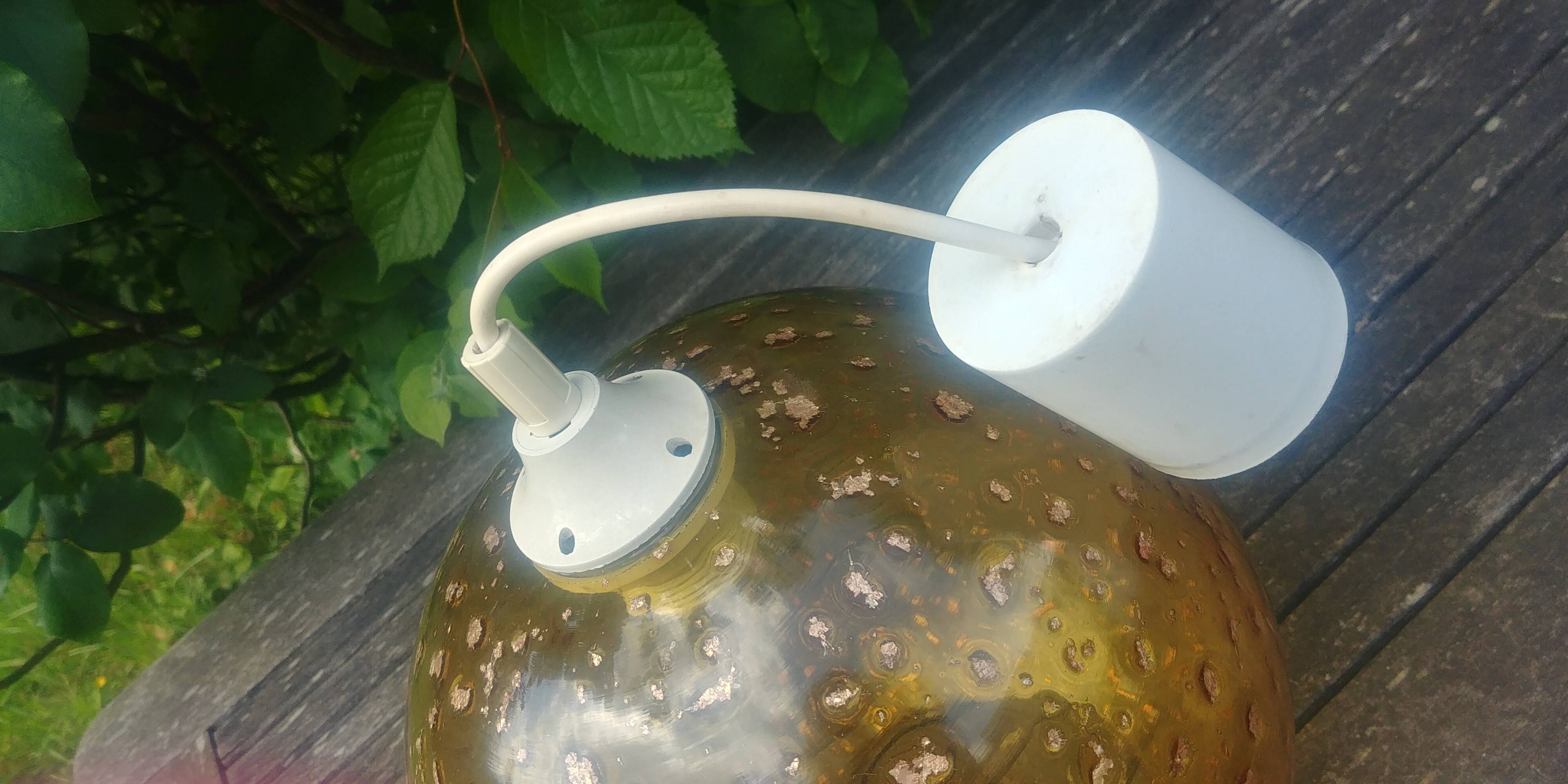 A vintage 70s blown glass pendant light with gold glitter in a globe shape