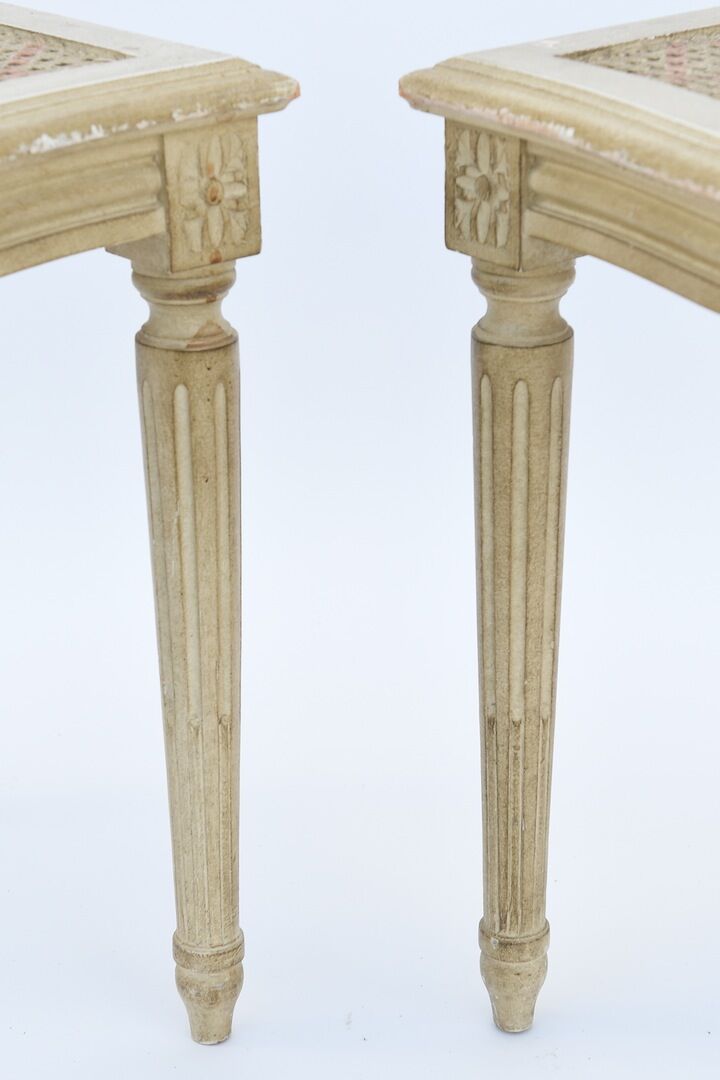 Pair of white canne and lay chairs