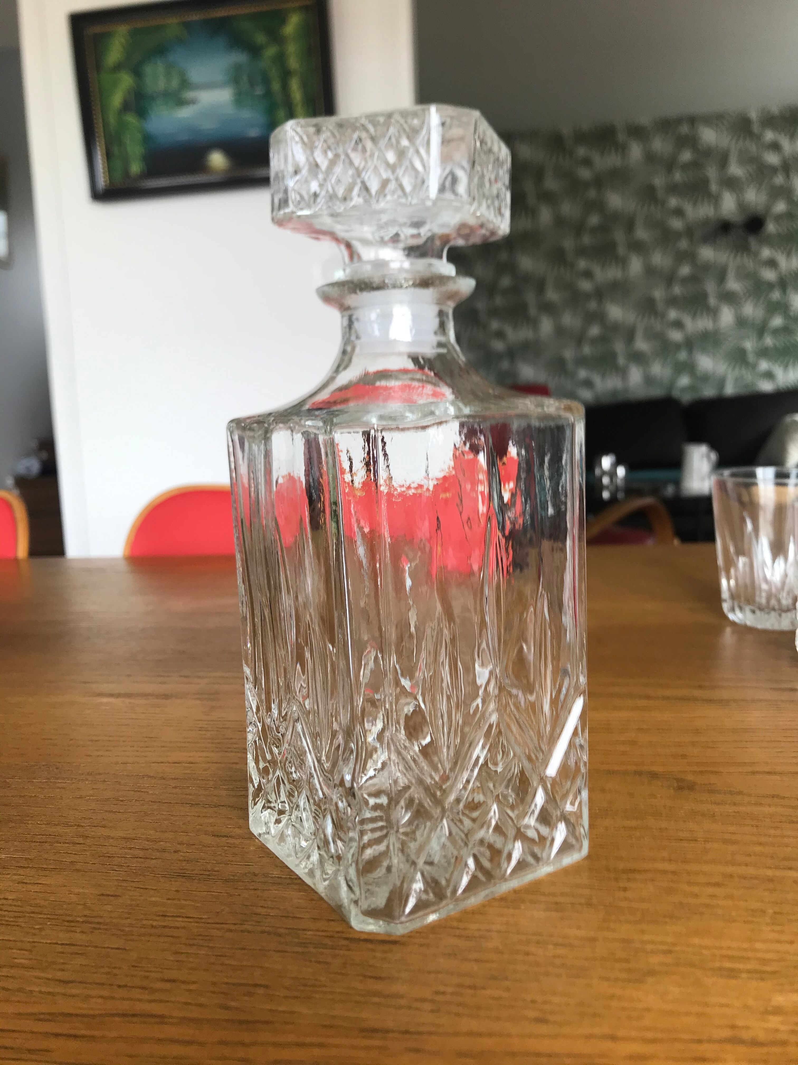 Mismatched decanter and whiskey glasses
