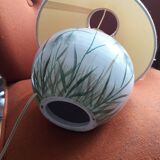 Antique ceramic lamp with a floral design.