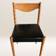 Set of 6 modernist chairs with black faux leather seats.