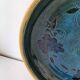 Blue floral glazed stoneware plate with a yellow rim.