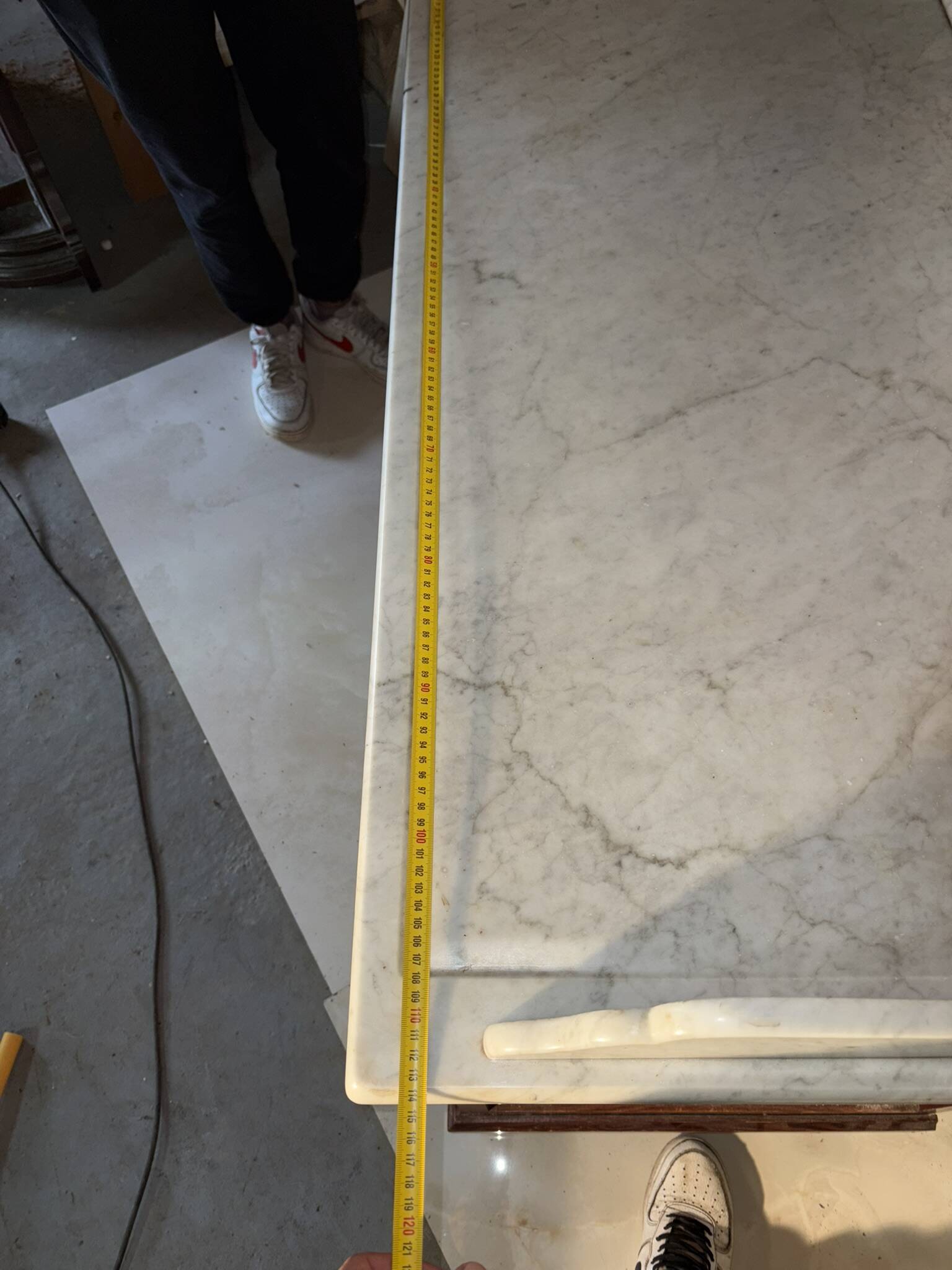 Antique wood and marble kitchen sideboard with carved backsplash