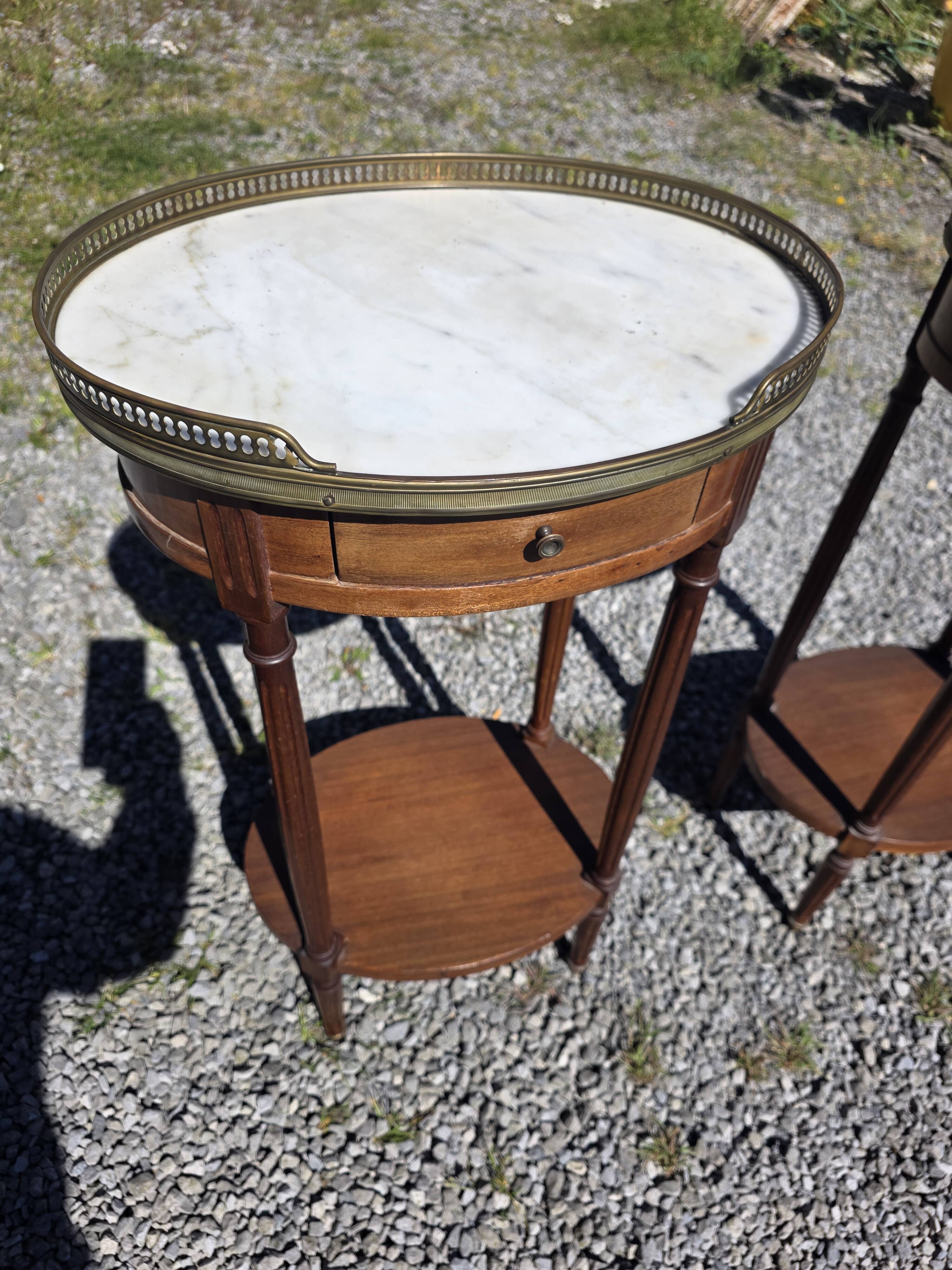 Pair of Louis XVI style bedside tables in mahogany, with marble tops.