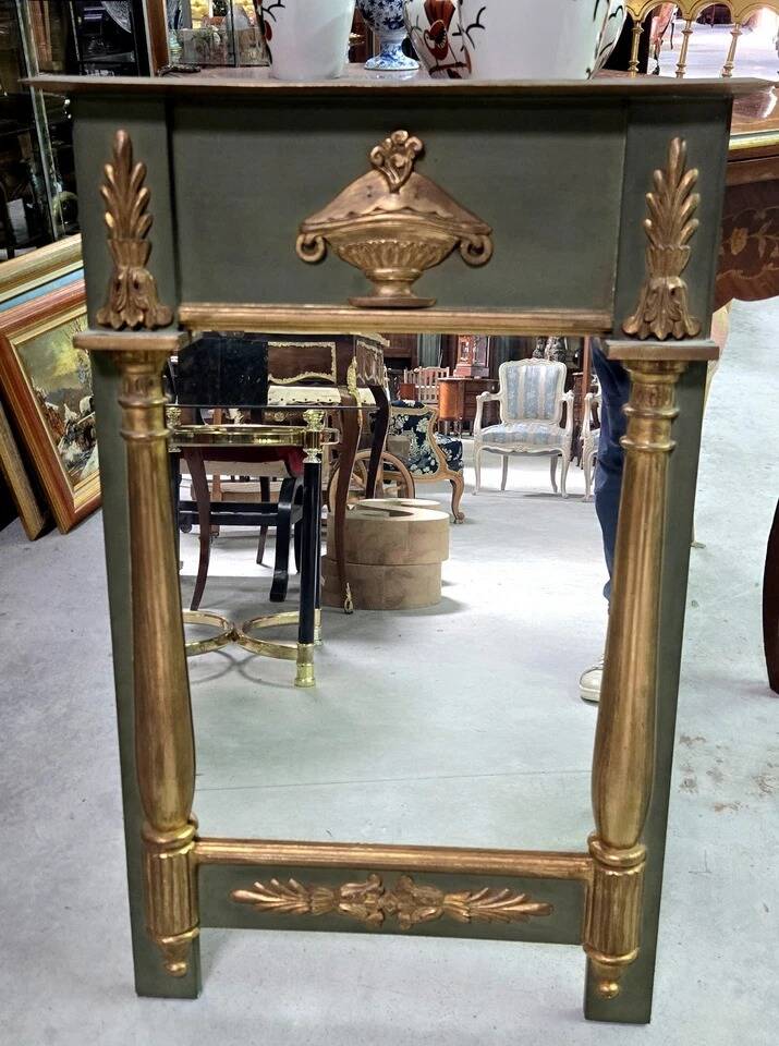 Empire-style mirror in deep green lacquered wood richly enhanced.