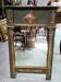 Empire-style mirror in deep green lacquered wood richly enhanced.