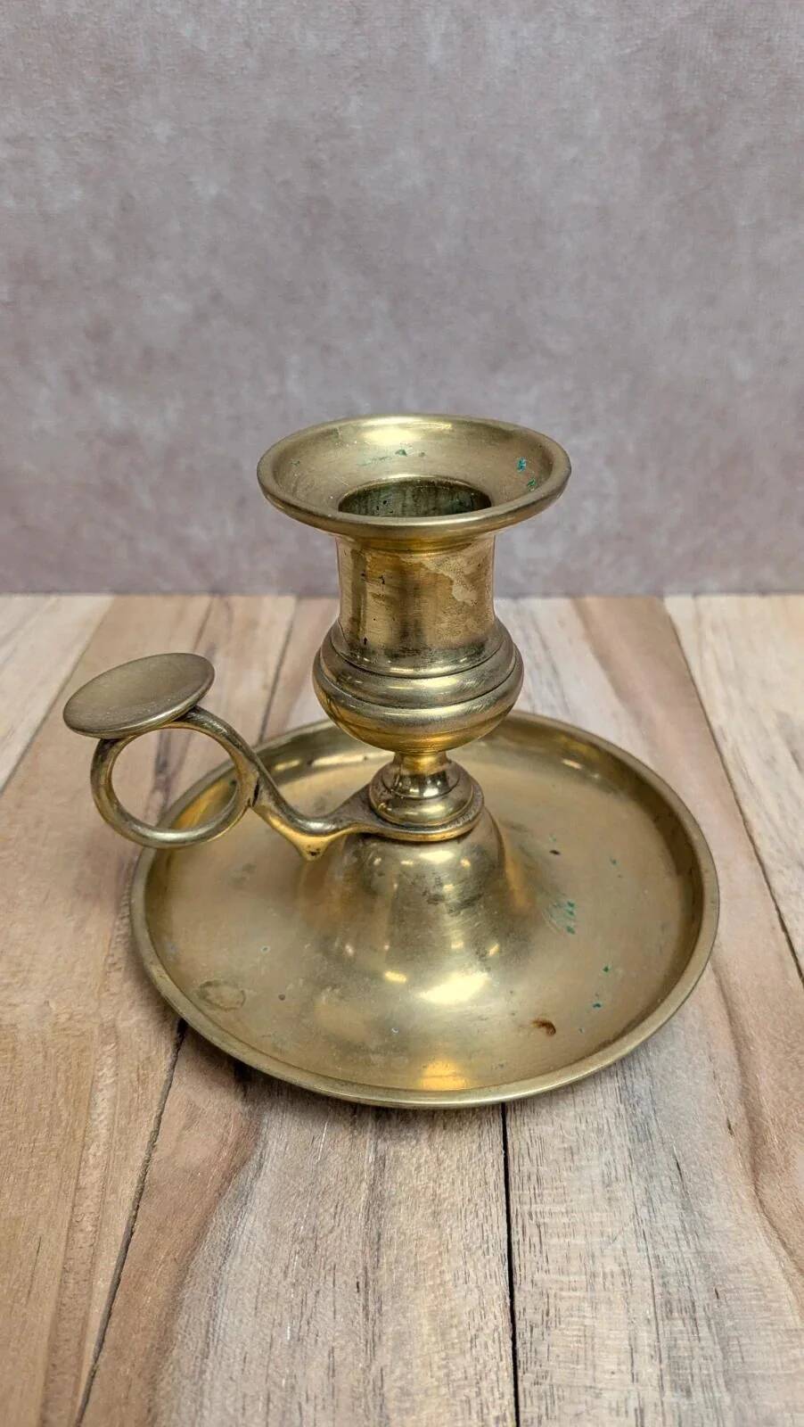 Antique brass candlestick with pusher