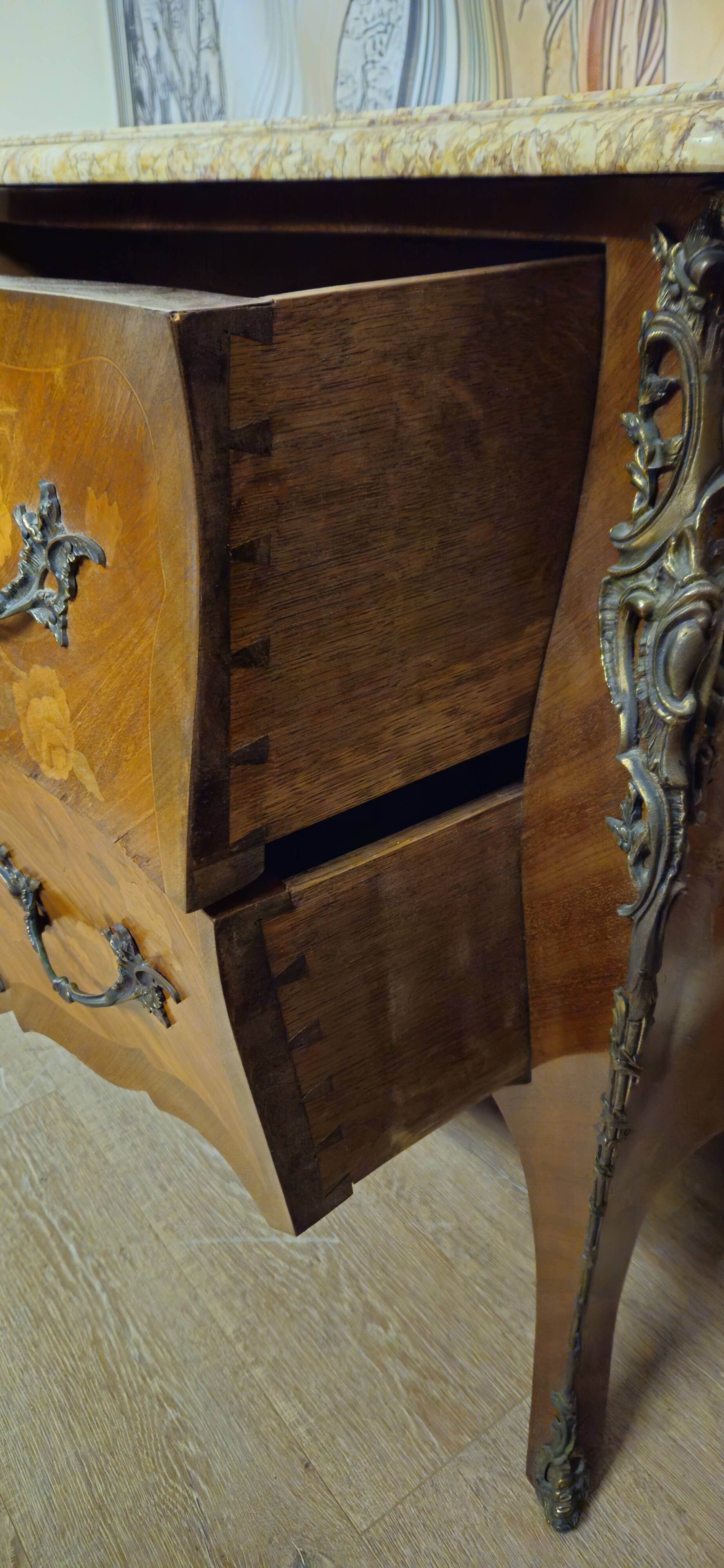 Curved Louis XV style commode with floral marquetry and marble top.