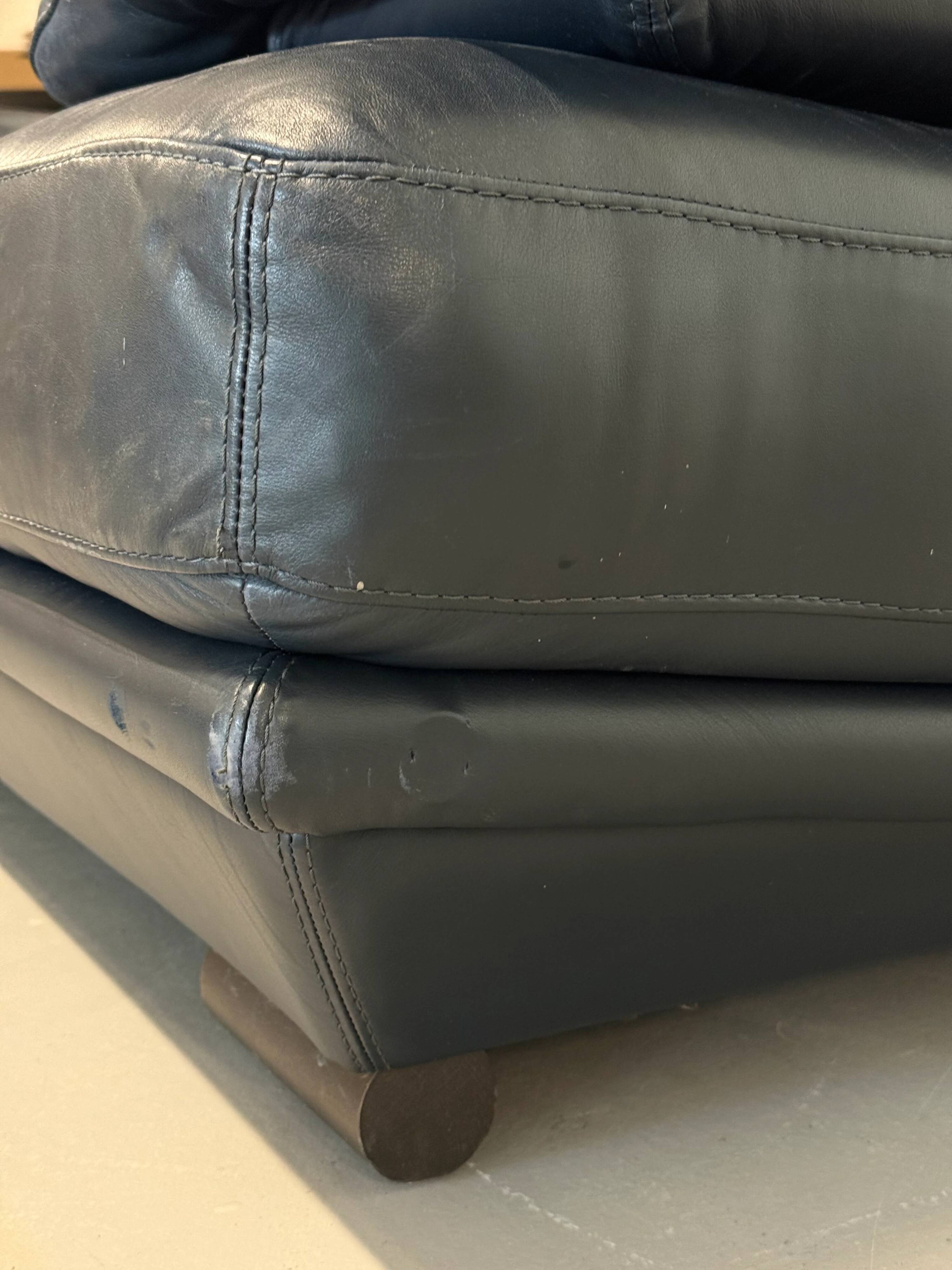 Two-seater Natuzzi sofa in navy blue leather.