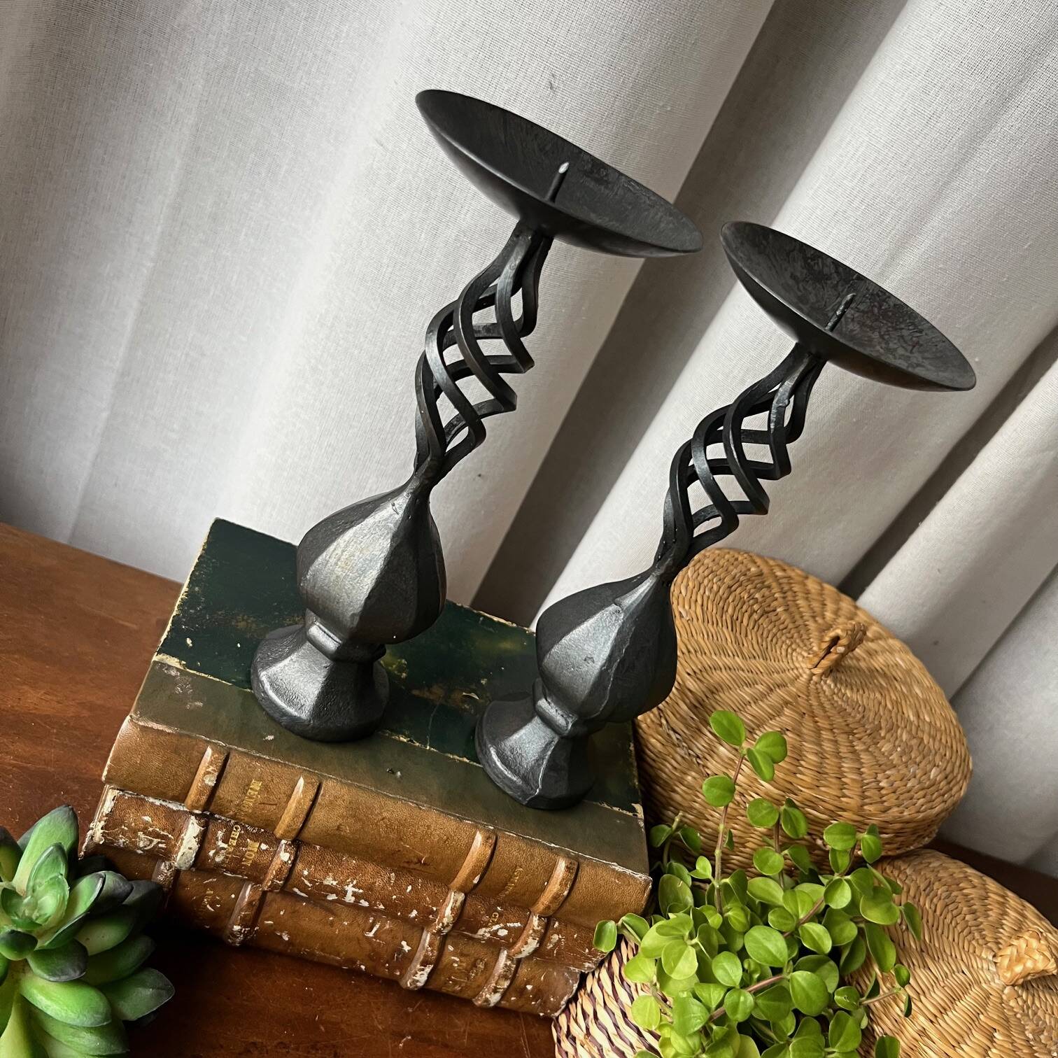 Pair of wrought iron candlesticks, black patina