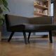 2-seater bench in black leather/PU with wooden legs