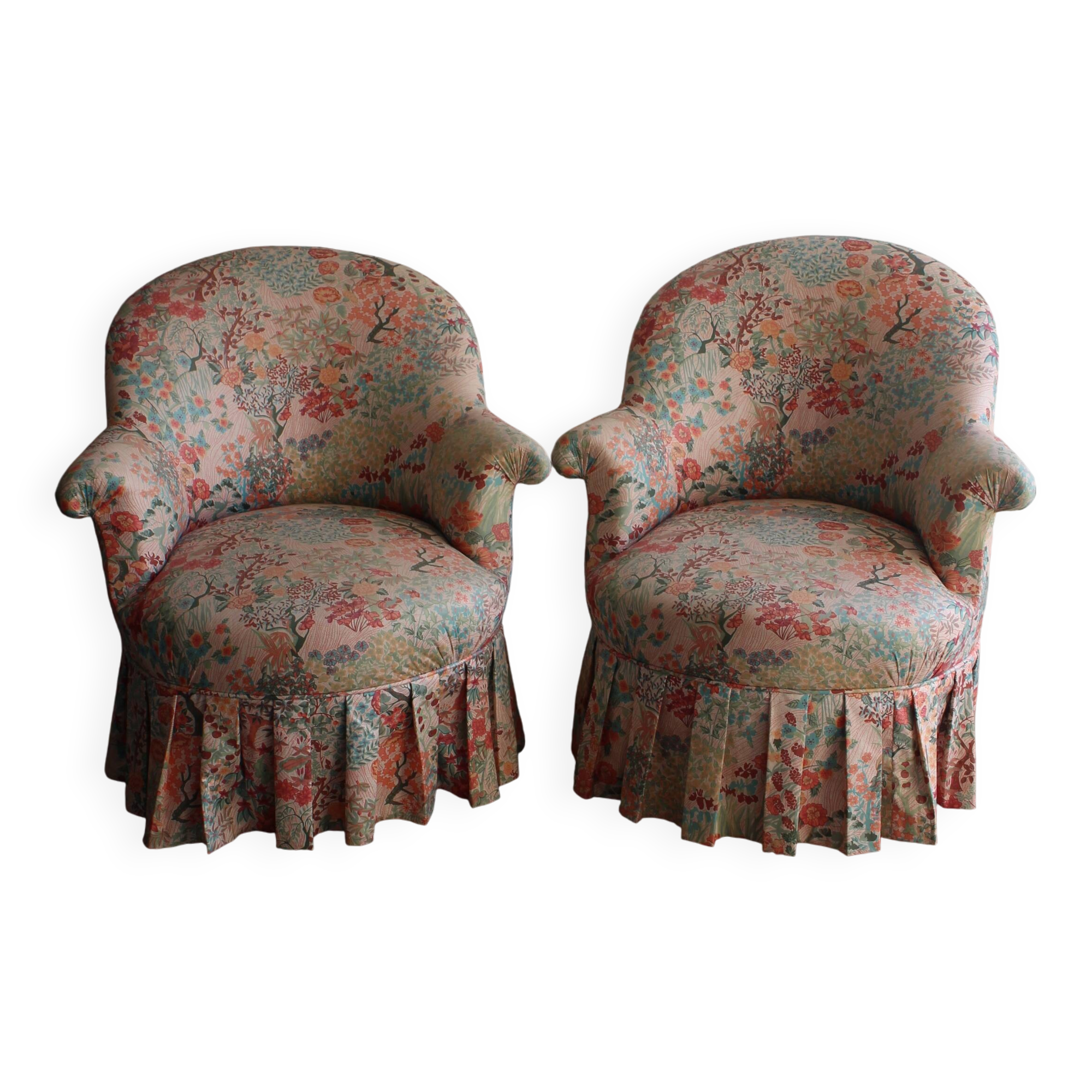 pair of toad armchairs in floral fabric.