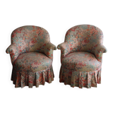 pair of toad armchairs in floral fabric.