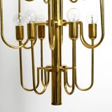 Three staged 18 arm Mid Century brass chandelier with a long brass rod