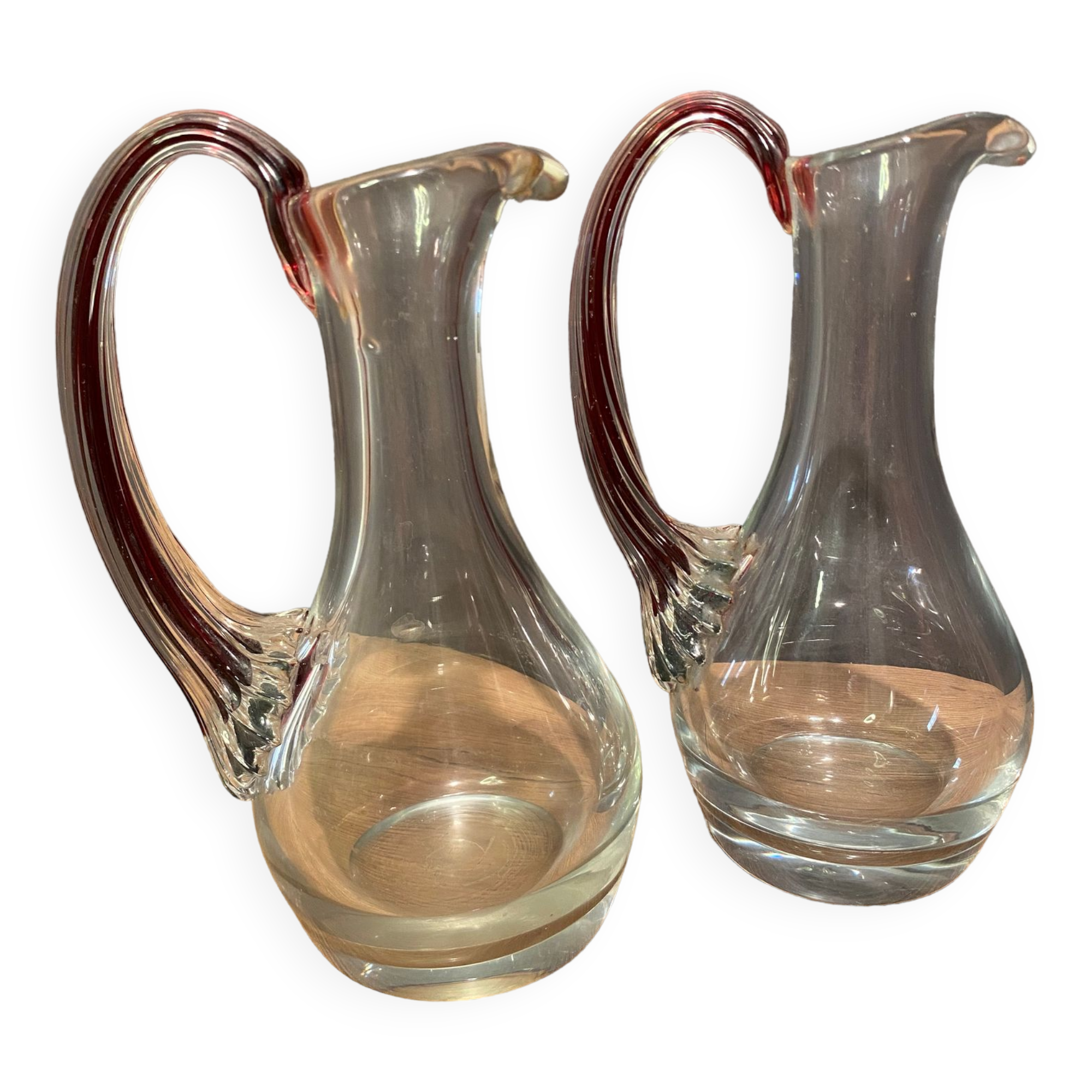 pair of crystal buires, handles with red tinted net decoration in the mass