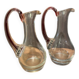 pair of crystal buires, handles with red tinted net decoration in the mass