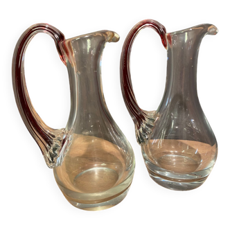 pair of crystal buires, handles with red tinted net decoration in the mass