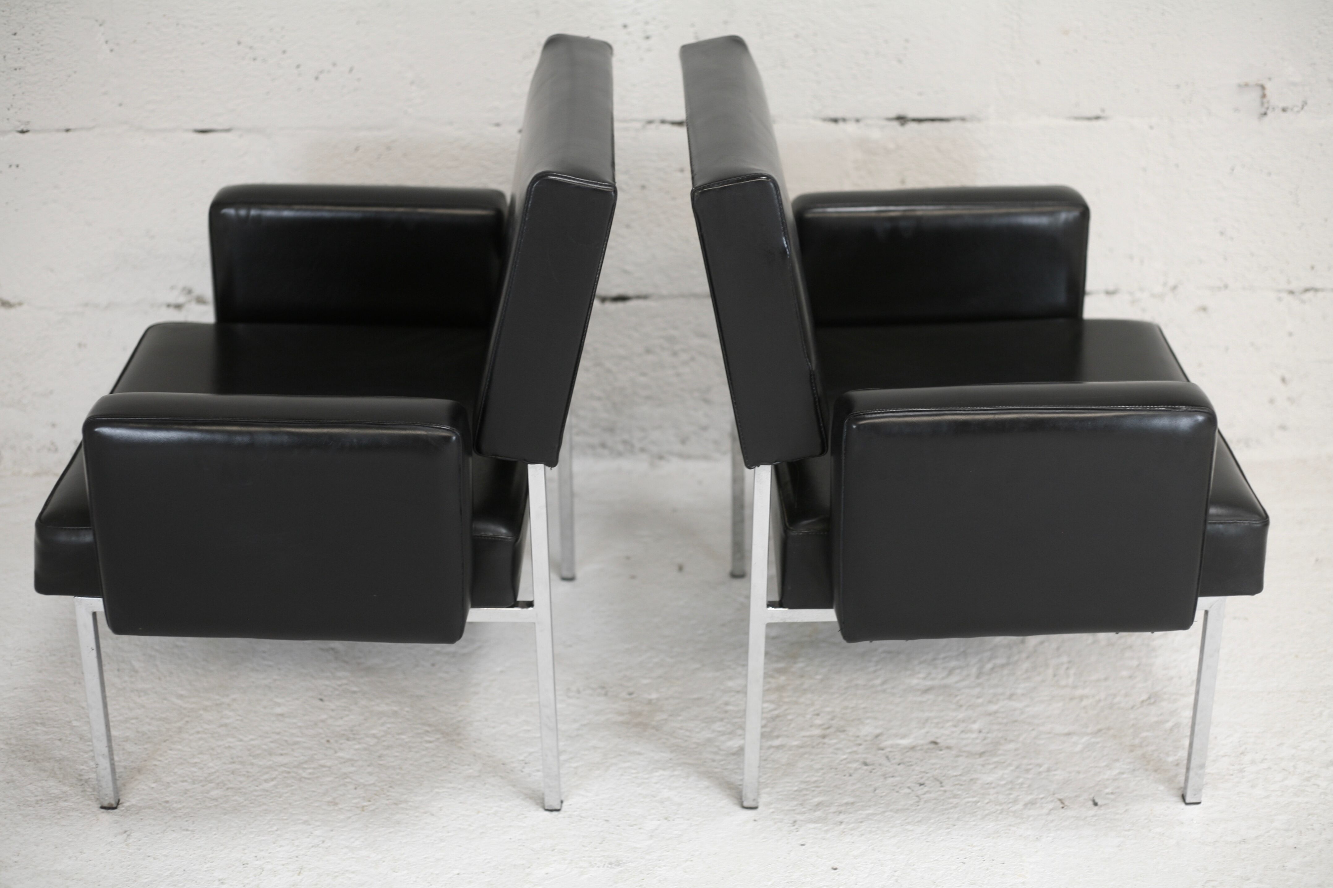 Pair of stainless steel, black leather-like armchairs, France, circa 1970