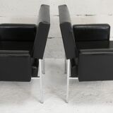 Pair of stainless steel, black leather-like armchairs, France, circa 1970