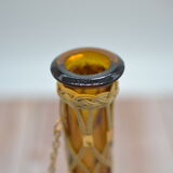 Amber decanter with wicker and golden chain