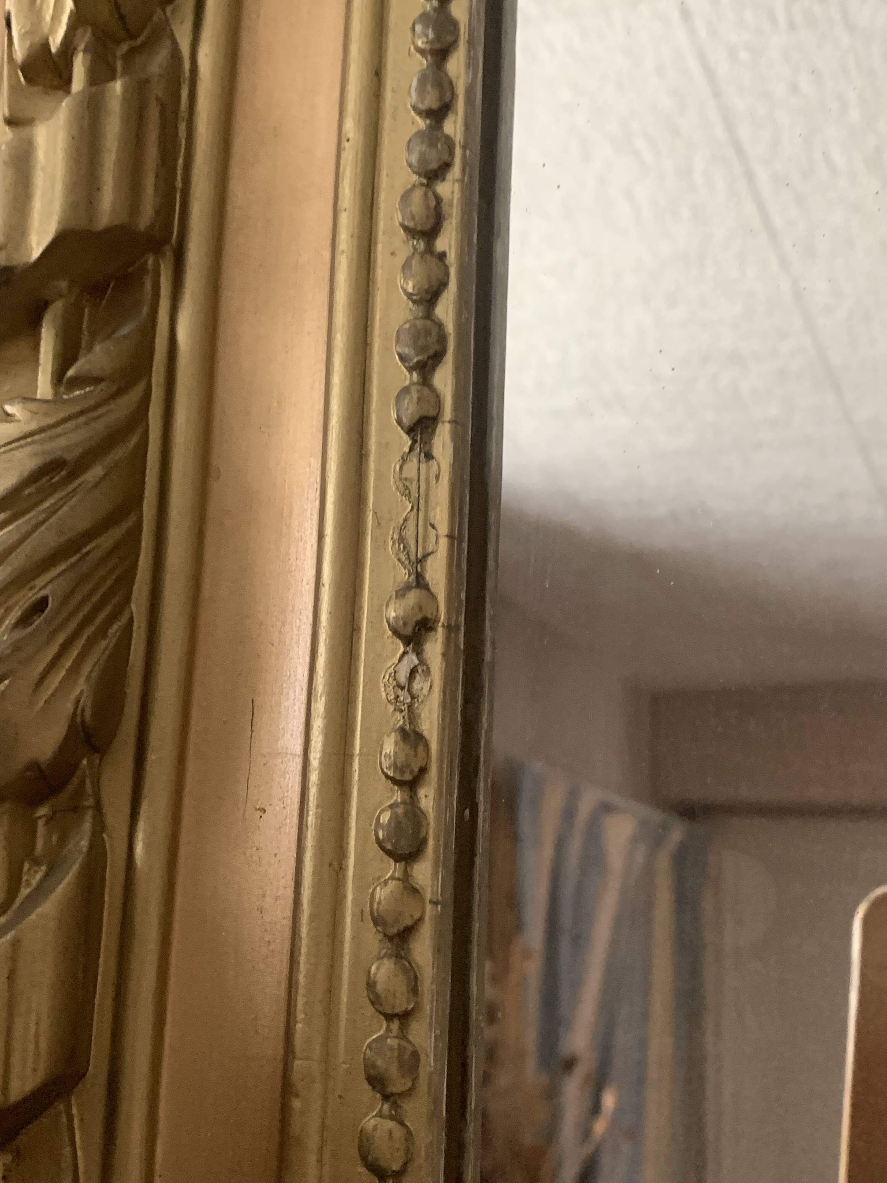 Gilded wooden fireplace mirror with pediment