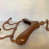 Wall mounted coat rack in the shape of a hanger