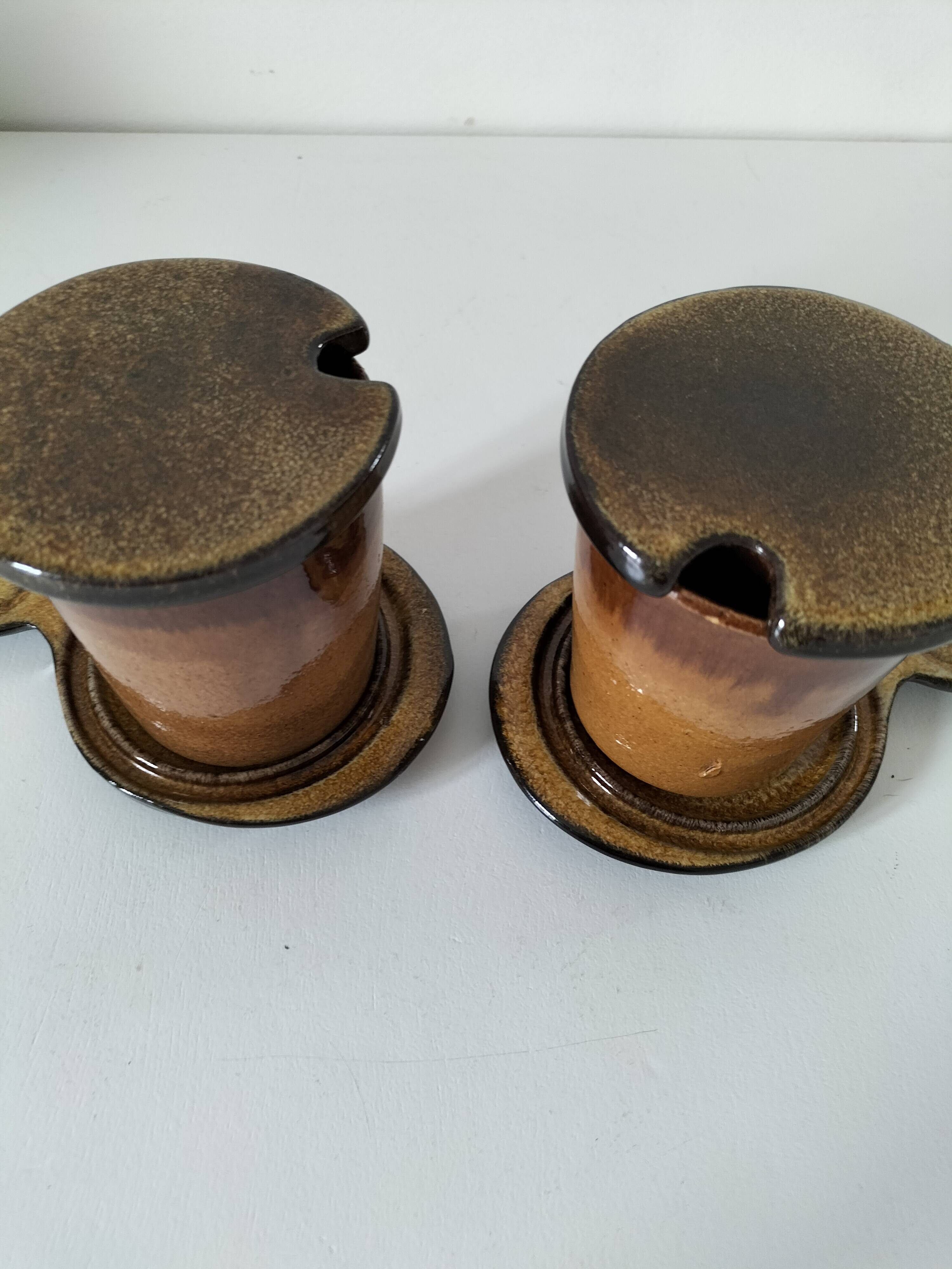 Pair of glazed stoneware cups with saucers and lids