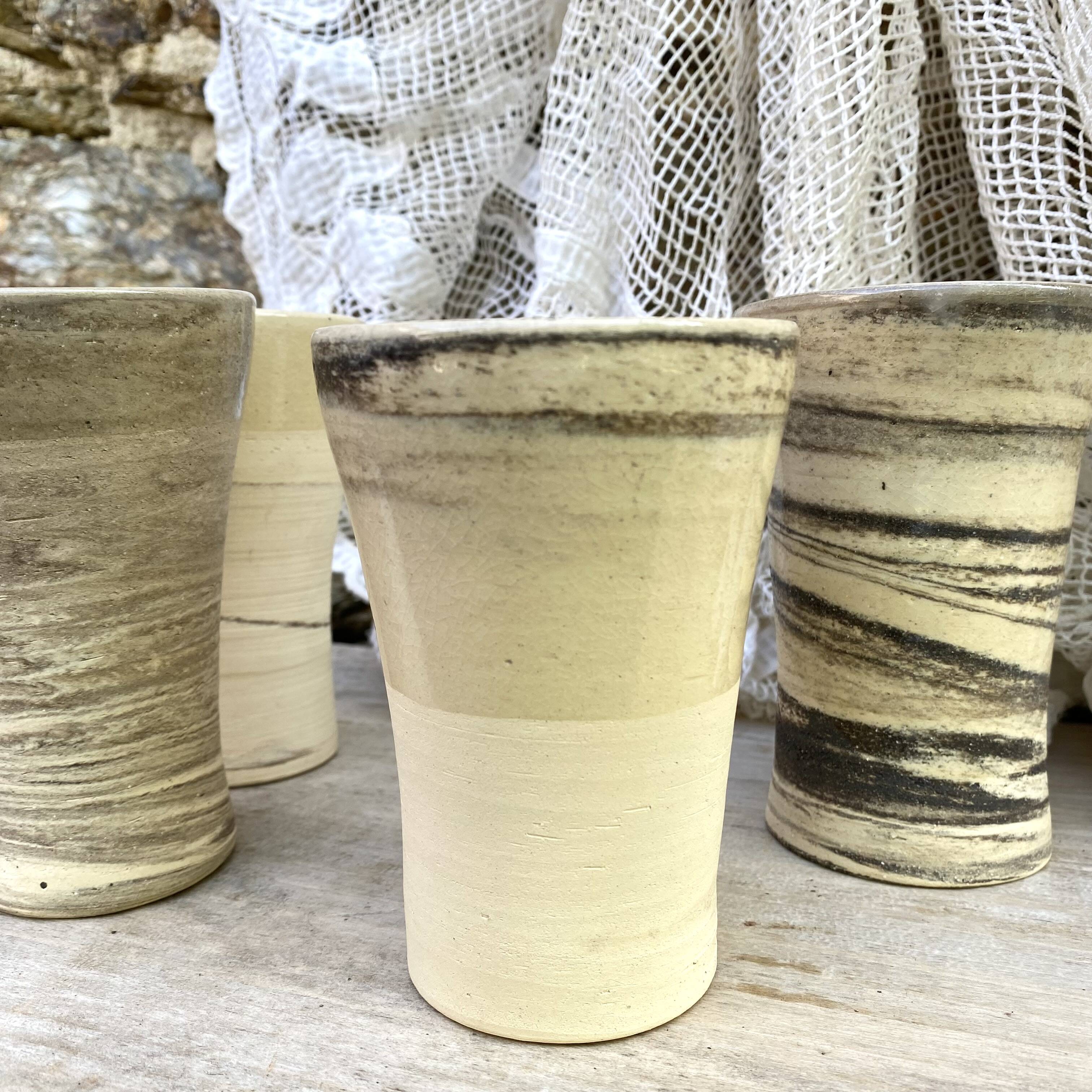 High ceramic cups made of mixed clay.