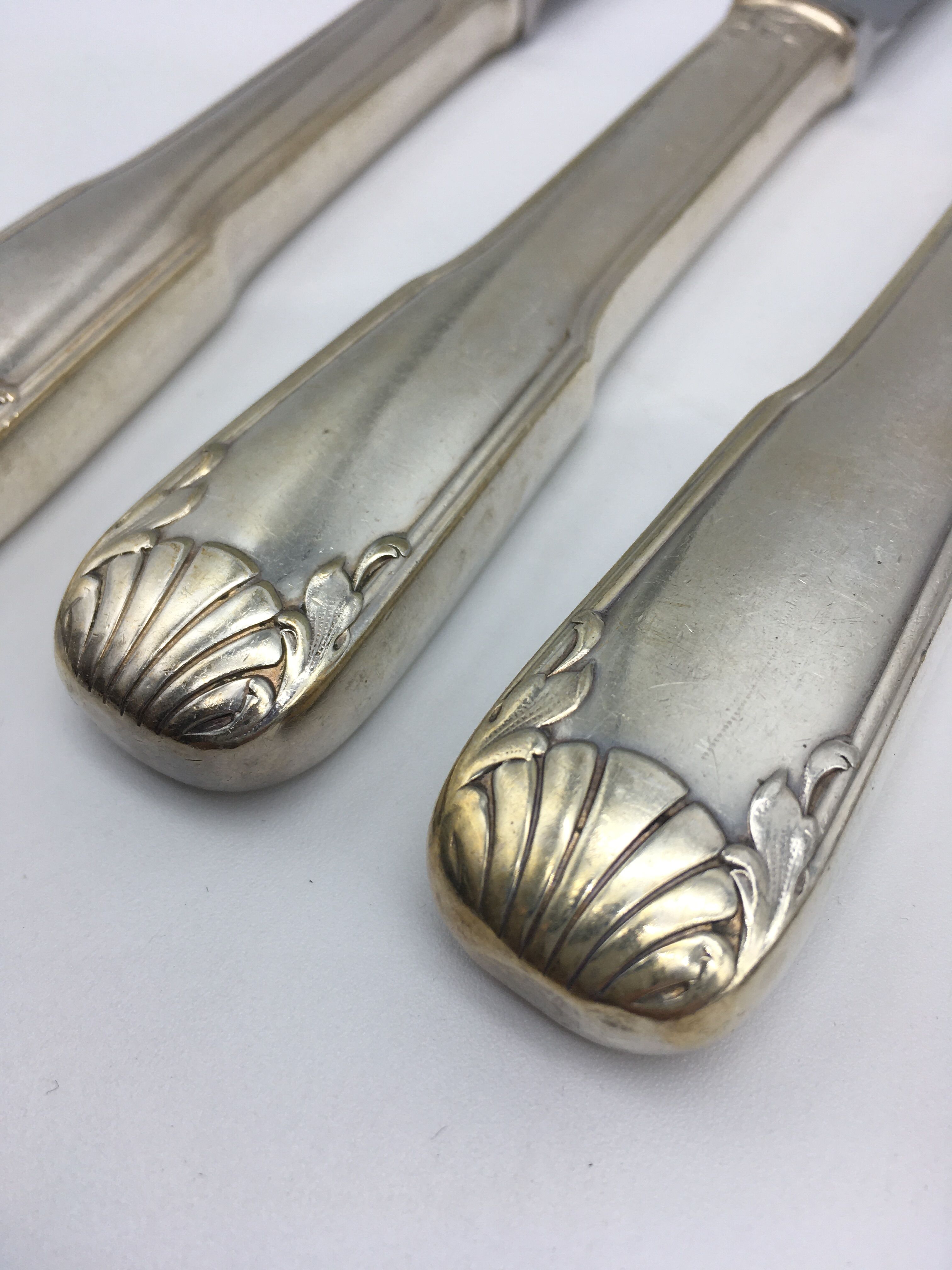 12 silver metal knives.