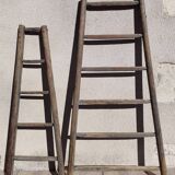 Two weathered wooden ladders H.135 cm