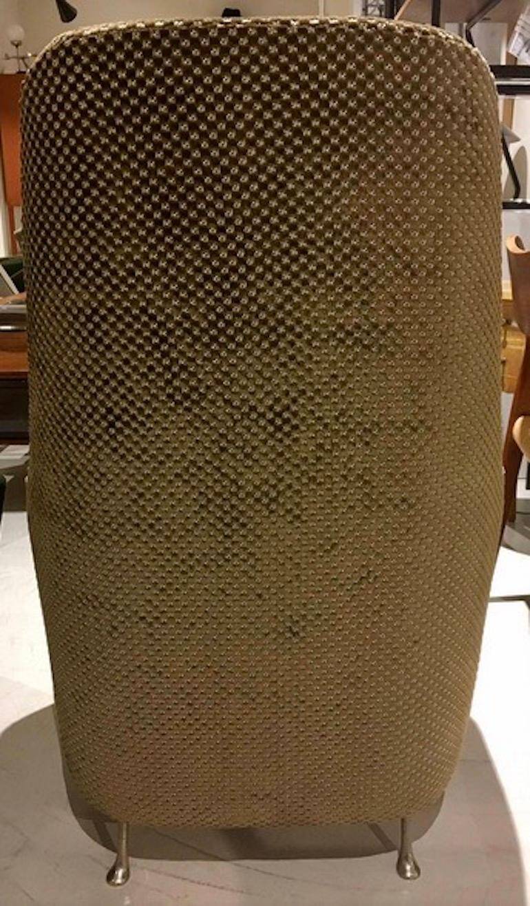 Mid-century buttoned armchair with metal legs