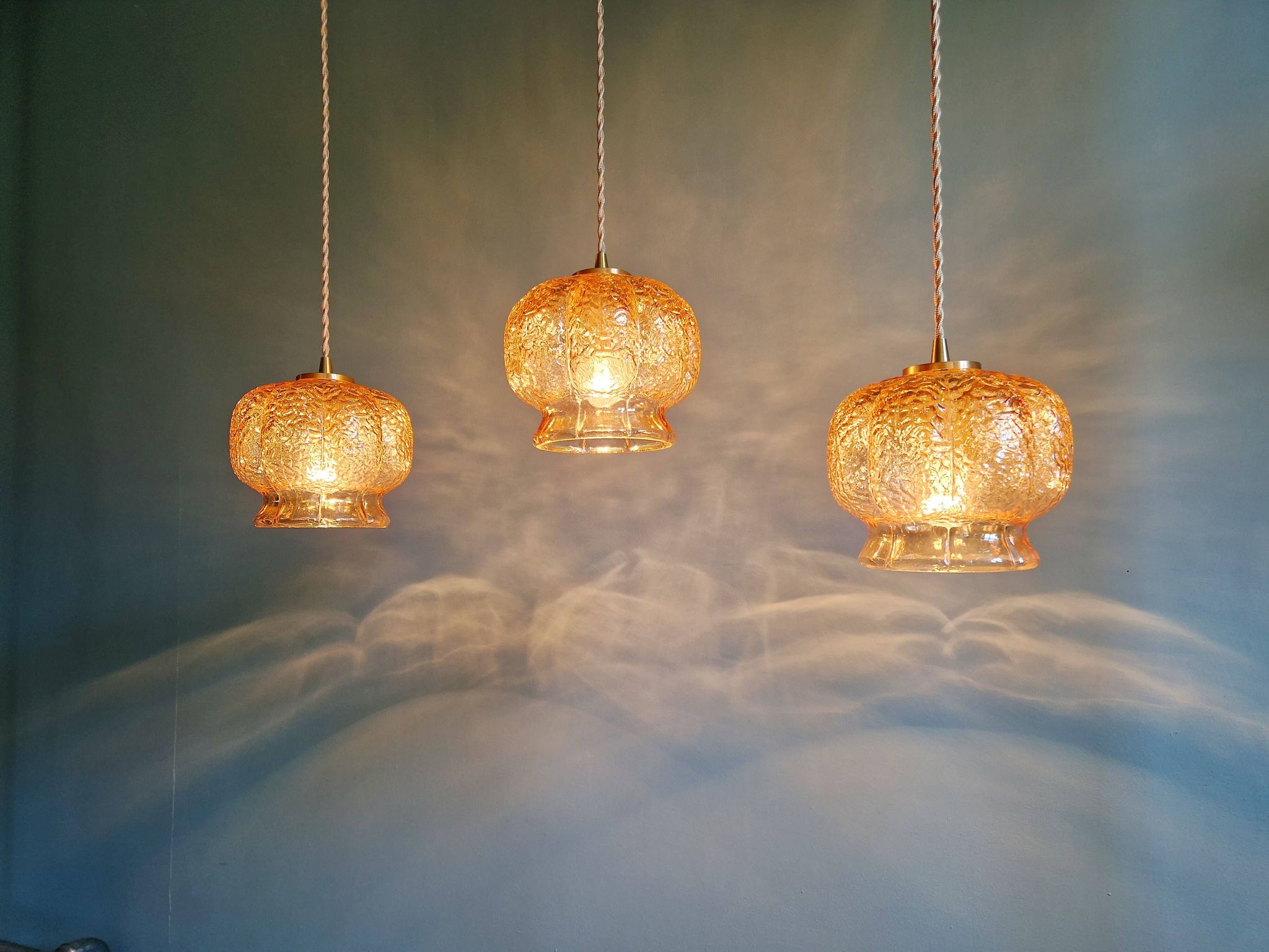Vintage trio of amber glass pendants, 1960s-70s.