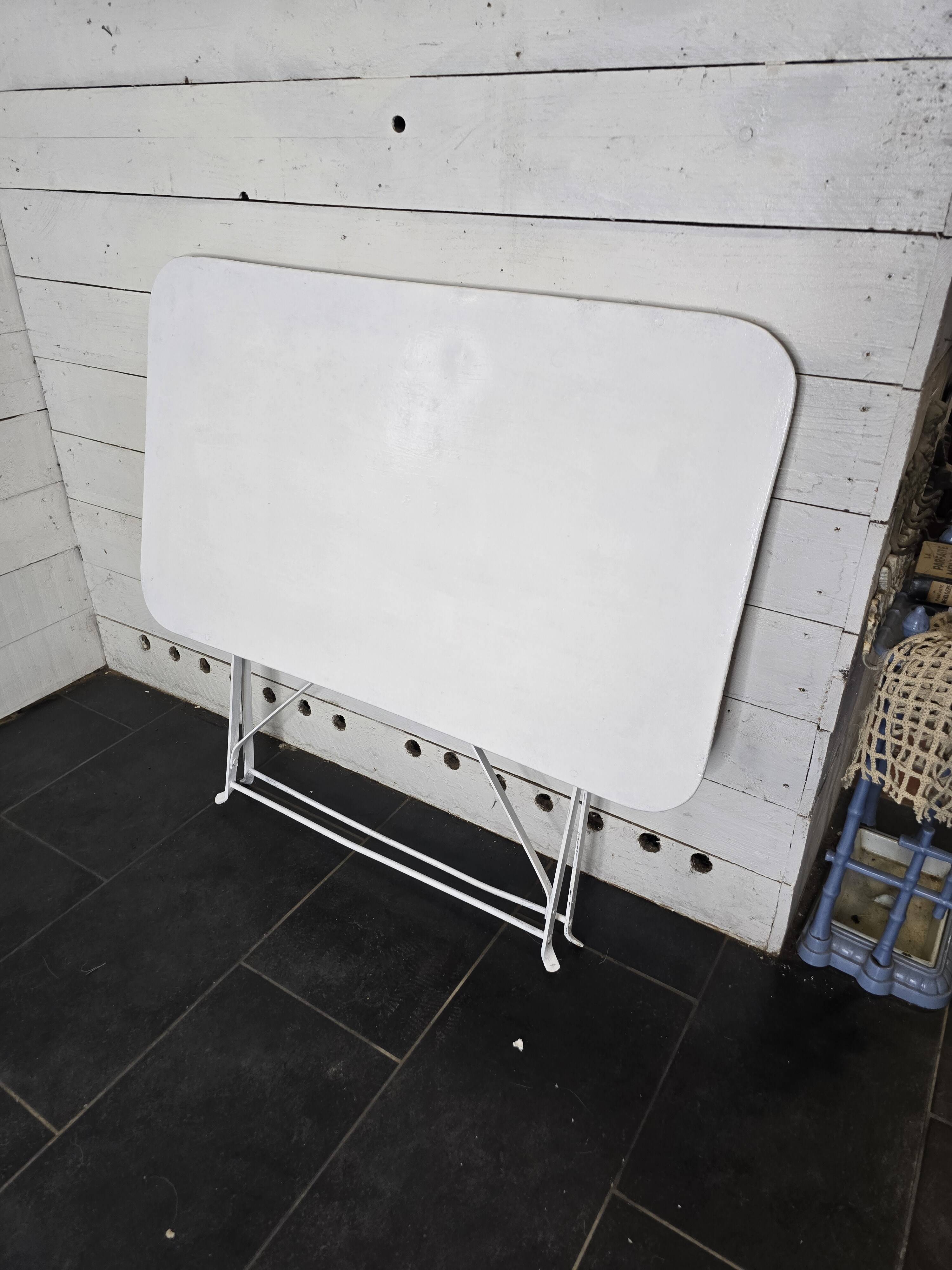 Old folding wrought iron garden table