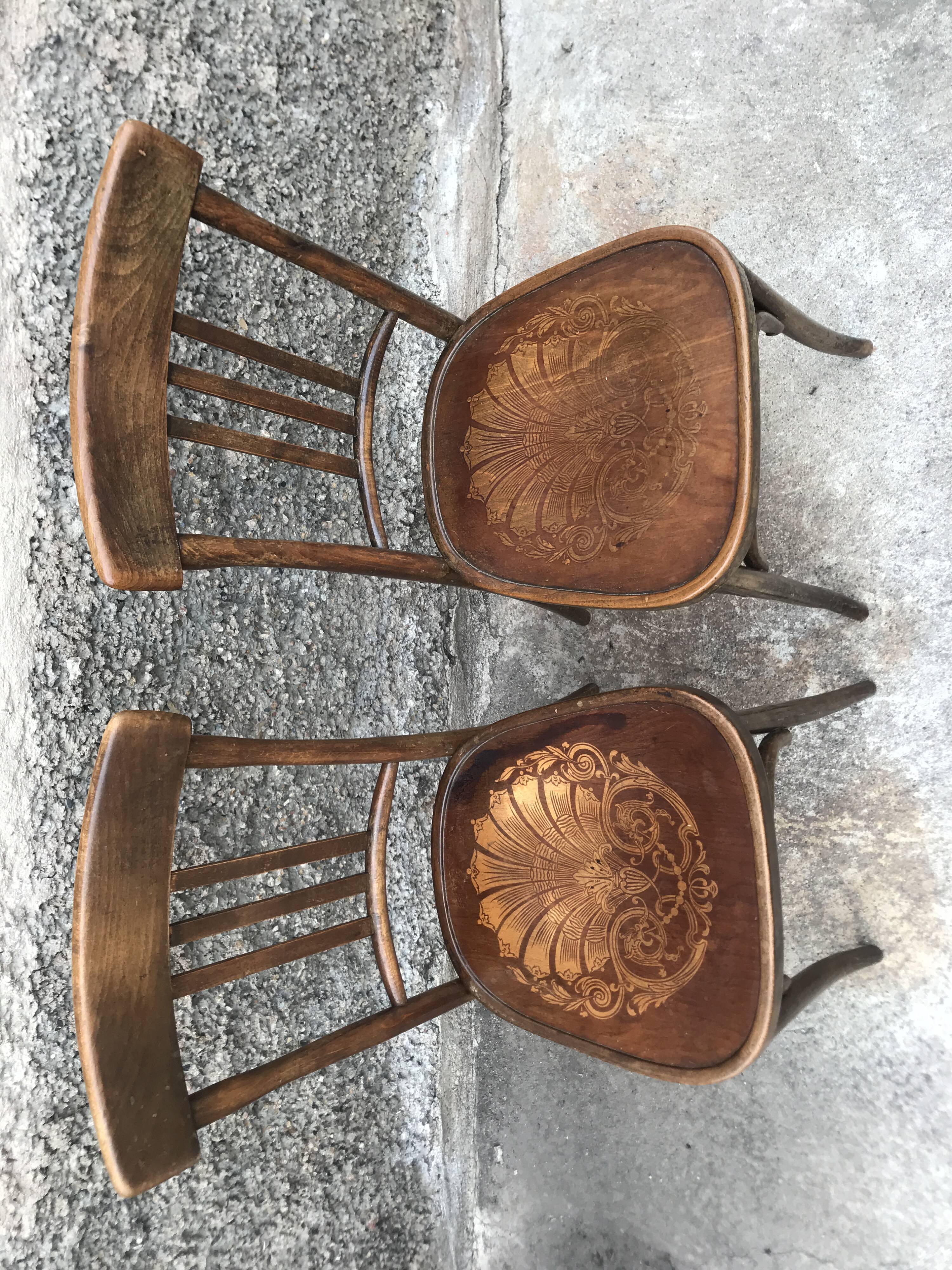 Pair of brasserie bistro chairs with seashell on seat