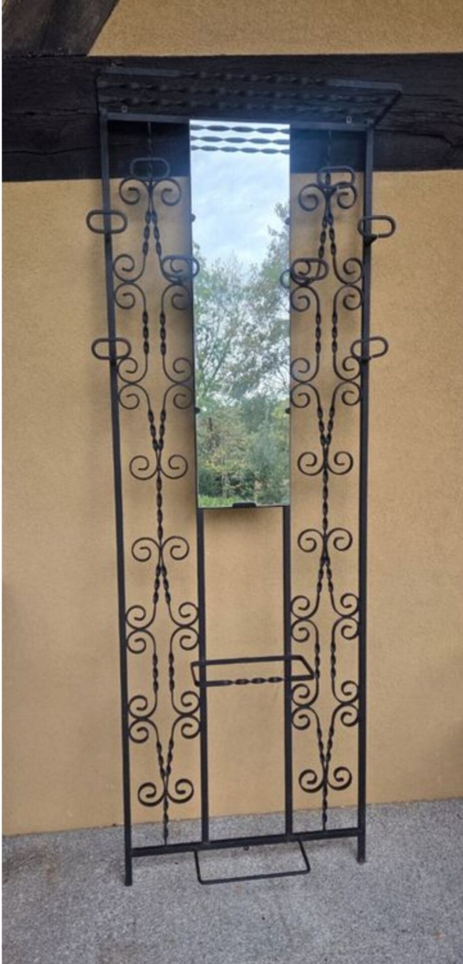 Large vintage wall coat rack in wrought iron with mirror and shelf.