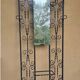 Large vintage wall coat rack in wrought iron with mirror and shelf.