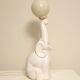 White ceramic table lamp, an elephant holding a lighted ball