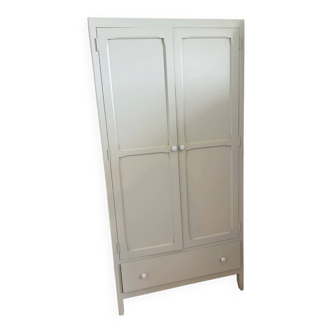 Mint green wardrobe with shelves and hanging space.