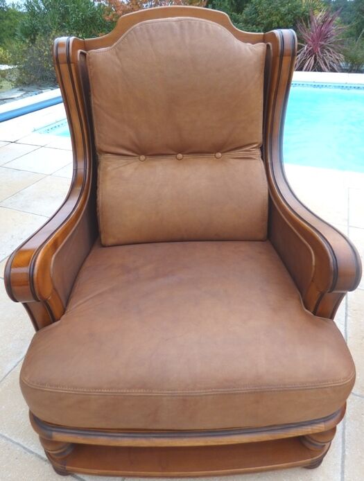 Pair of aged leather armchairs with seat and firm backrest with cherry wood frame